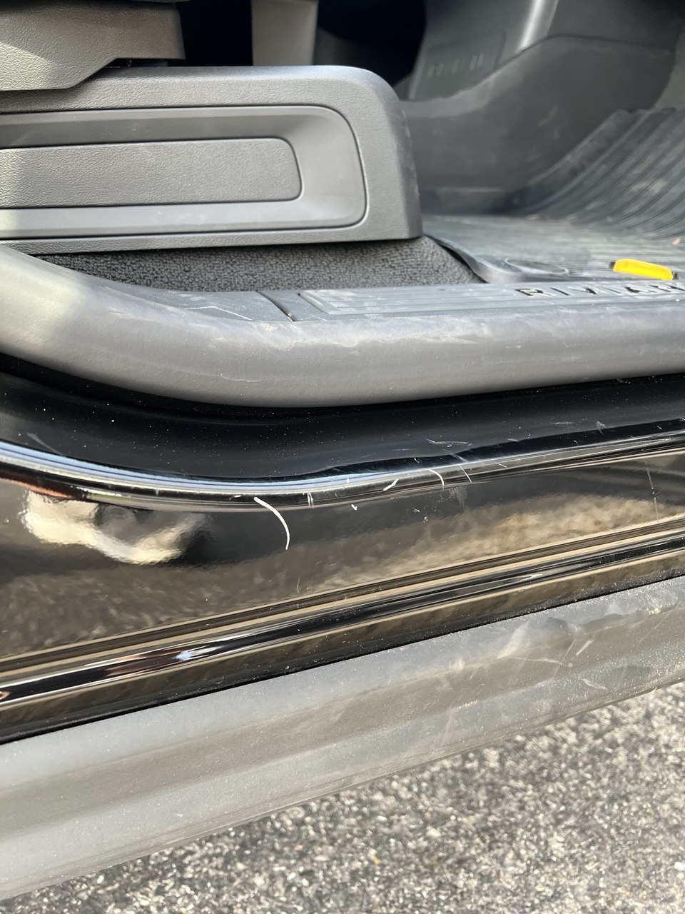 Scratches on Rivian R1S door sill before touch-up paint