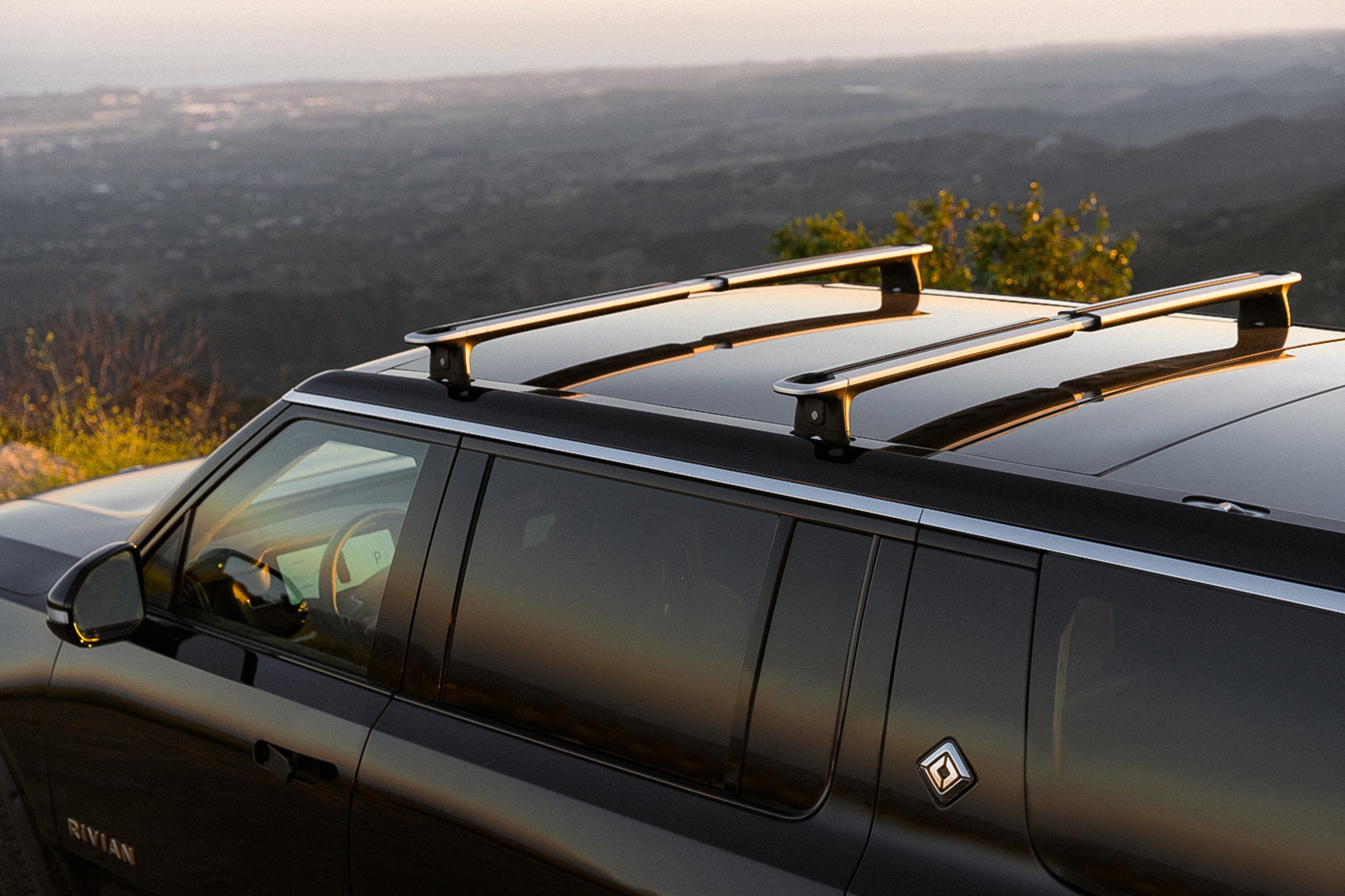 Rivian vehicle in an outdoor adventure setting — the lifestyle these savings unlock